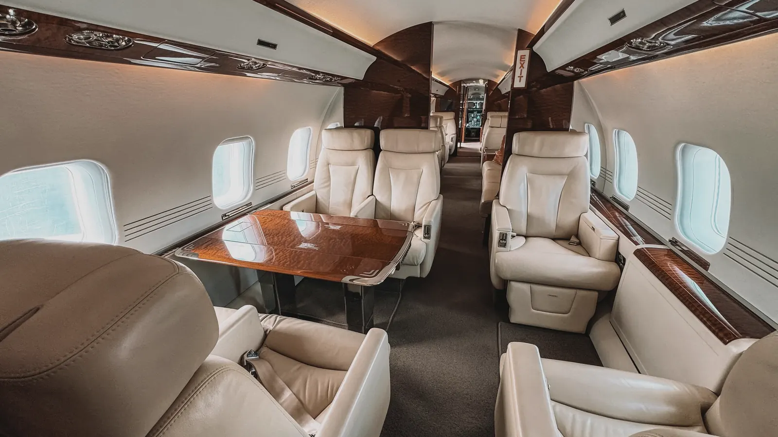 Cabin, illustrative of the class: a dining group that seats four and a galley crew can work in flight.