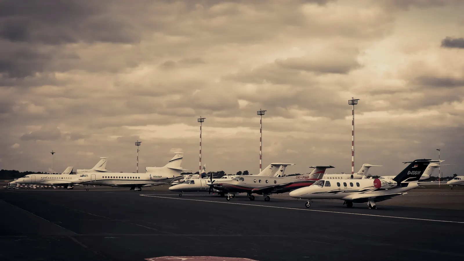 Private jets repositioning on the ramp at dusk