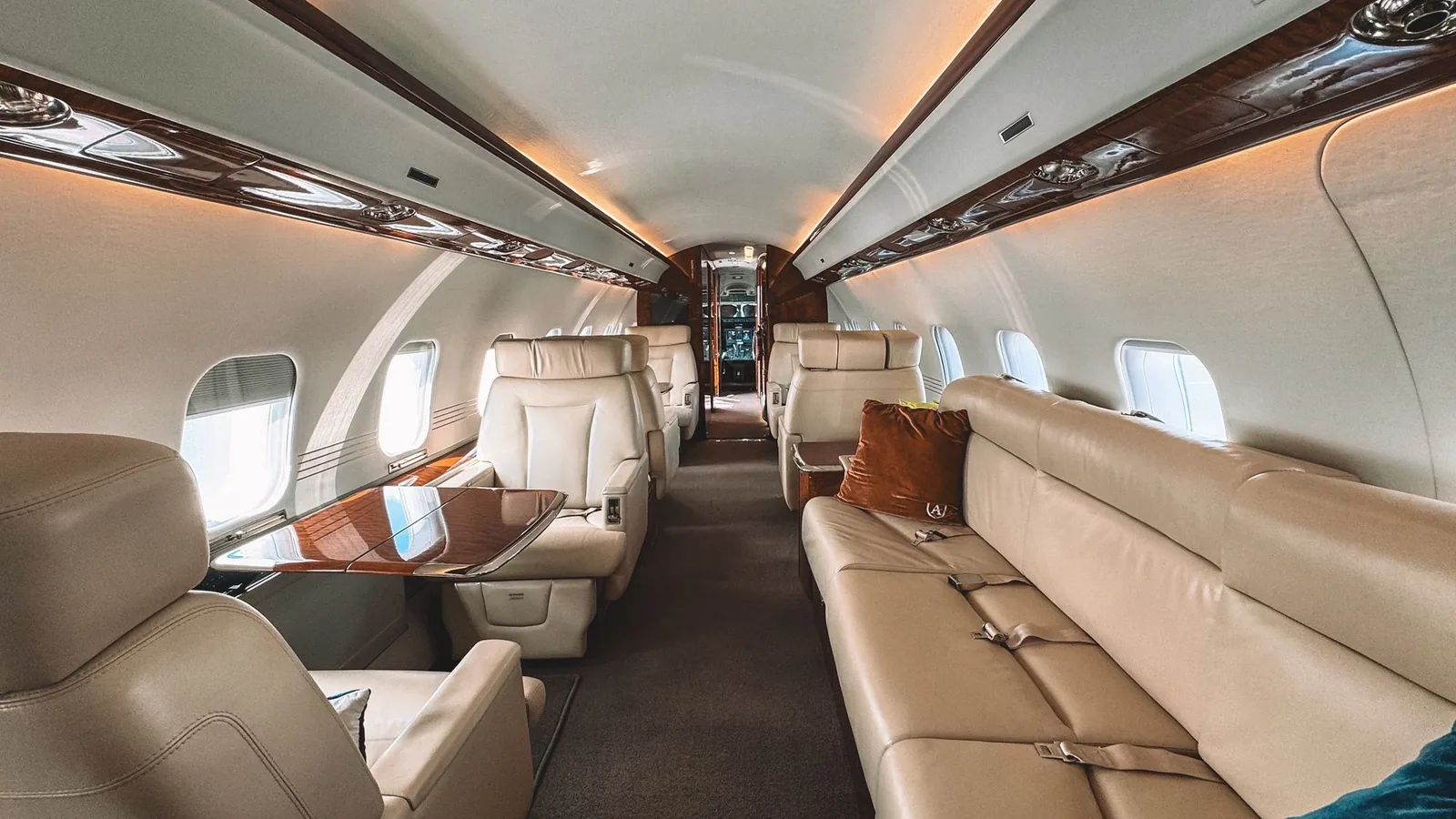 Leather seats and wood trim in a private jet cabin