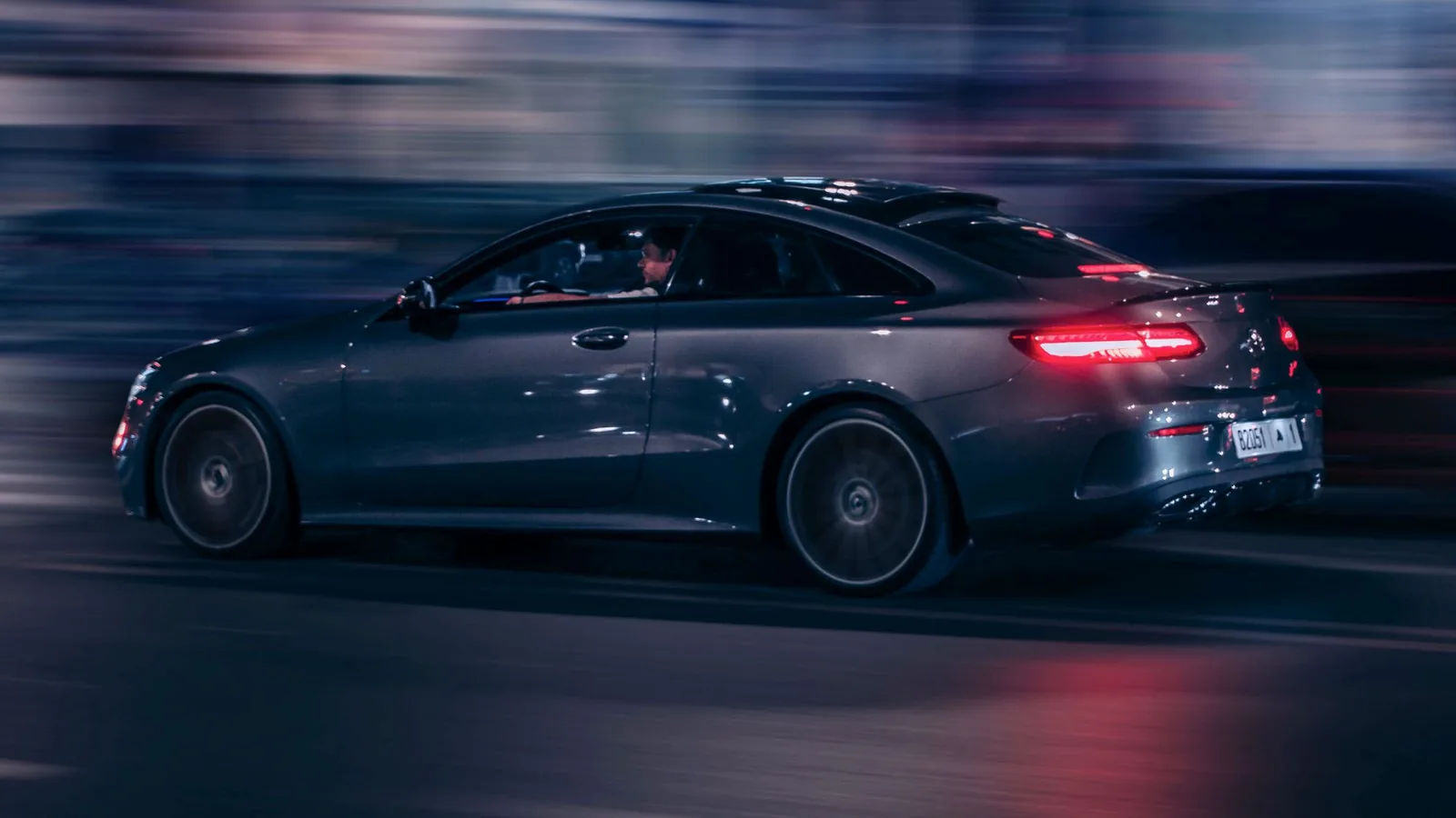 Luxury car on a city street at night